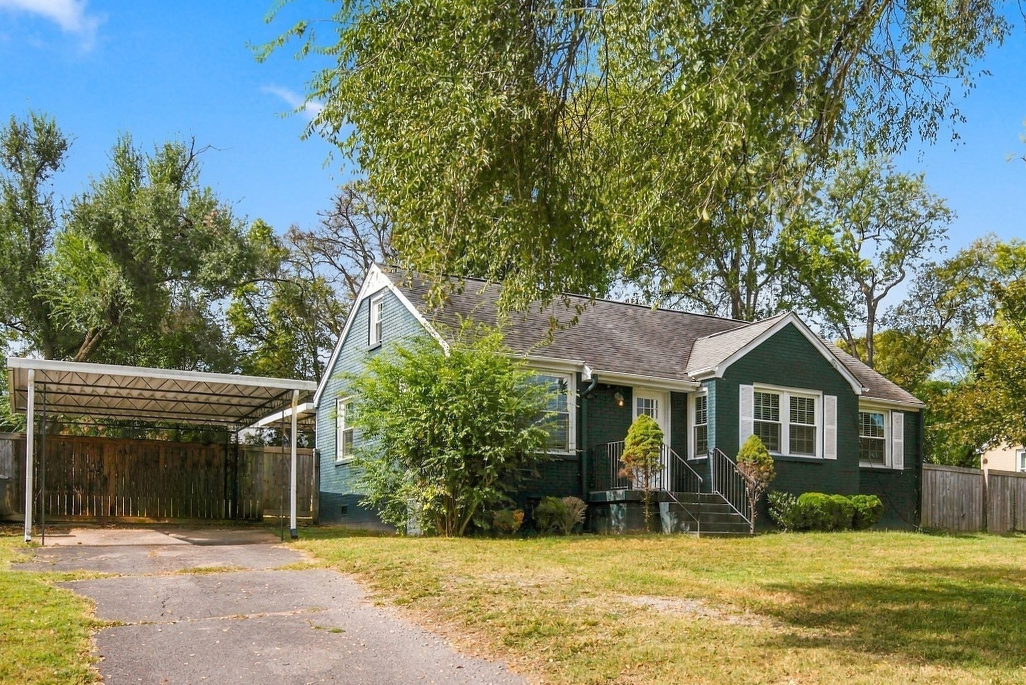 Side view of 2214 Fernwood Drive showing the carport and driveway in East Nashville