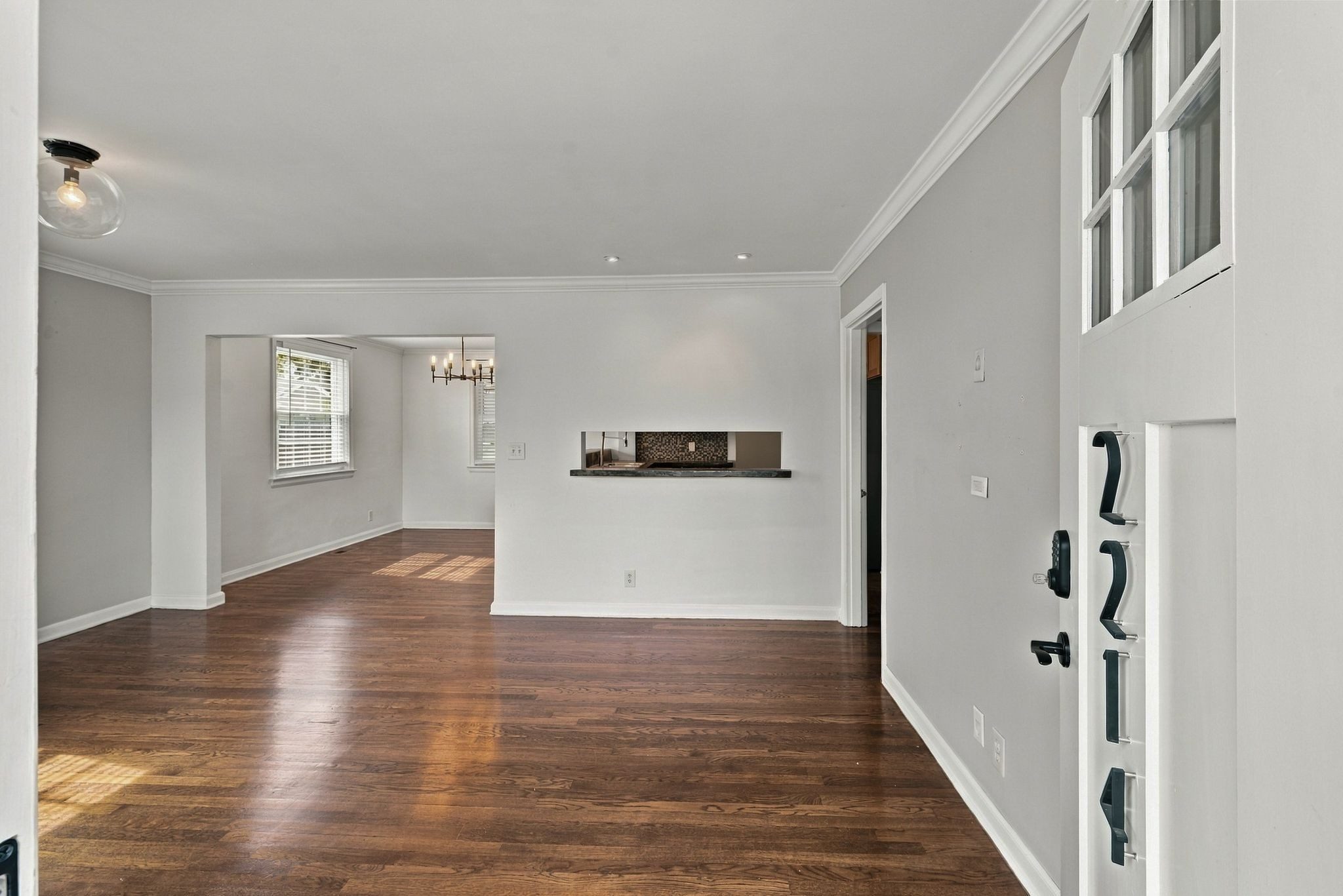 Living room with refinished hardwood floors and an opening to the dining area at 2214 Fernwood Drive in East Nashville