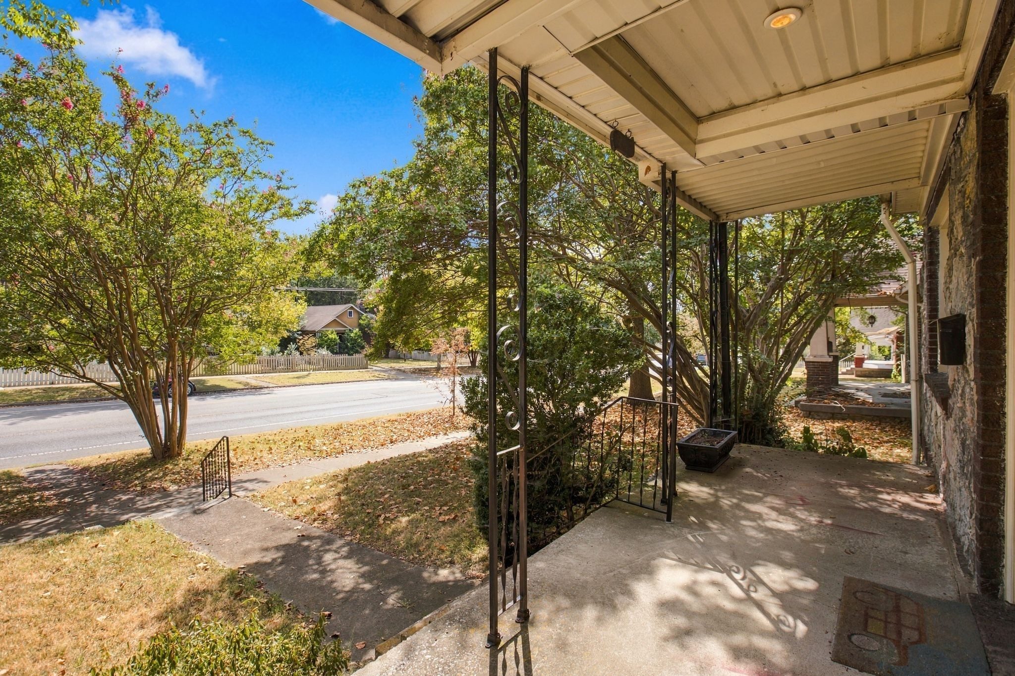 Covered front porch with iron posts looking out to Shelby Avenue at 711 Shelby Avenue in East Nashville